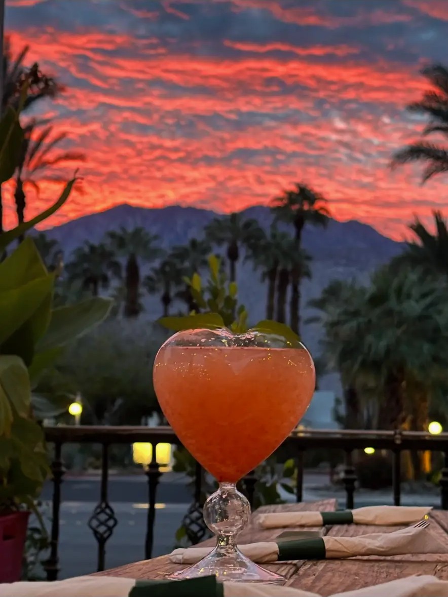A colorful Felipe’s cocktail overlooking the Palm Springs mountains at sunset
