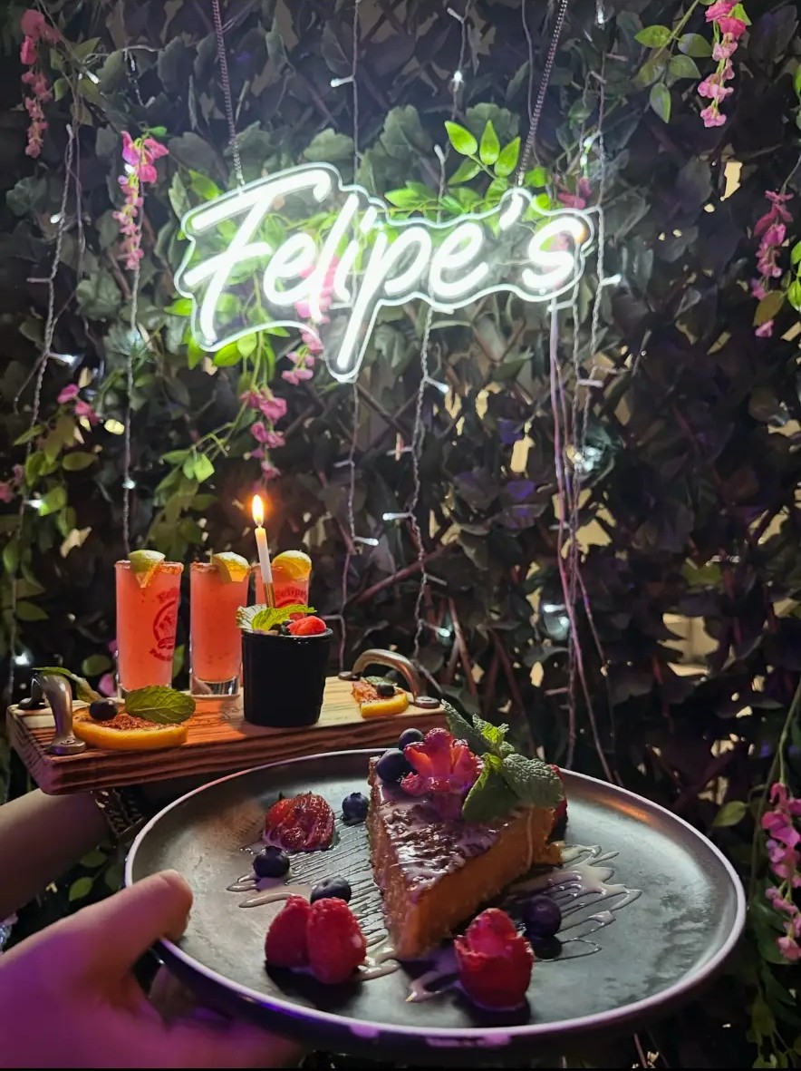 Felipe’s dessert and drinks presented beneath the restaurant sign